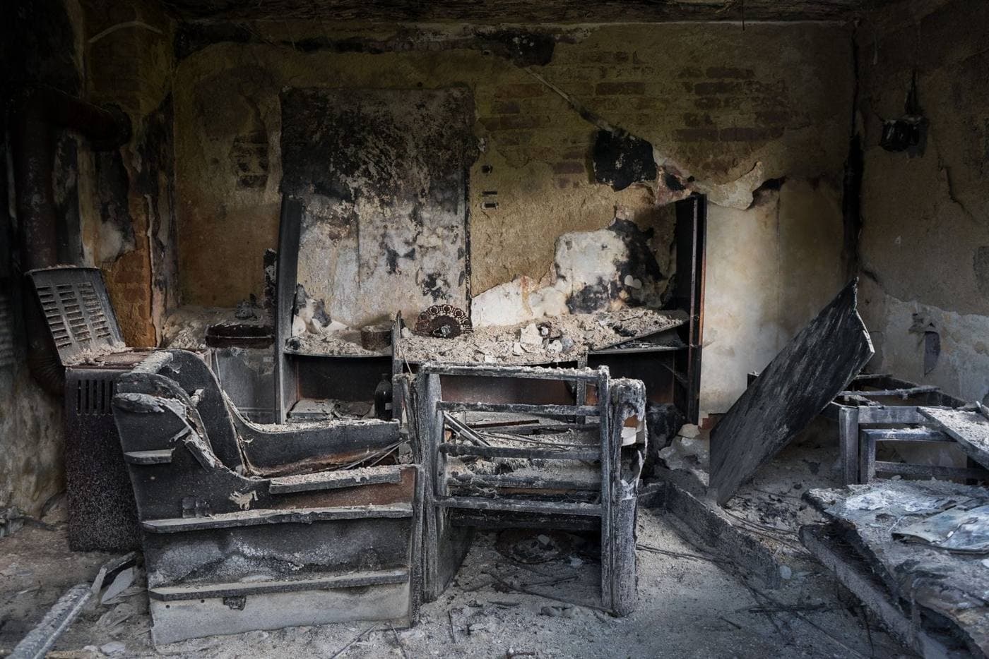 Charred furniture inside a burned room