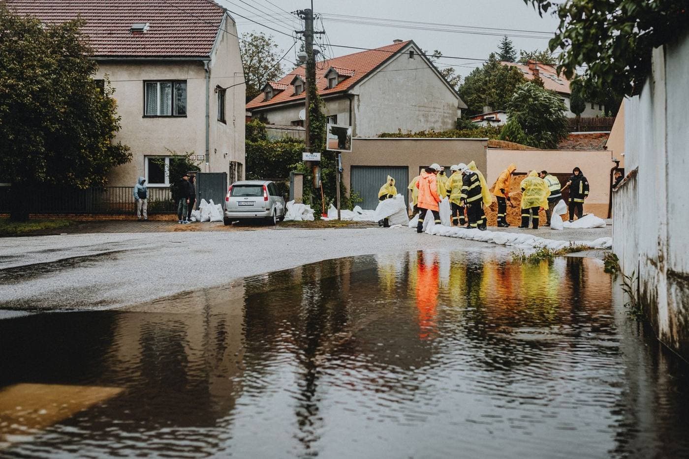 Crews working along a flooded residential street