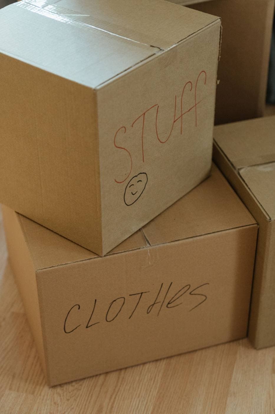 Moving boxes labeled for clothes and other belongings