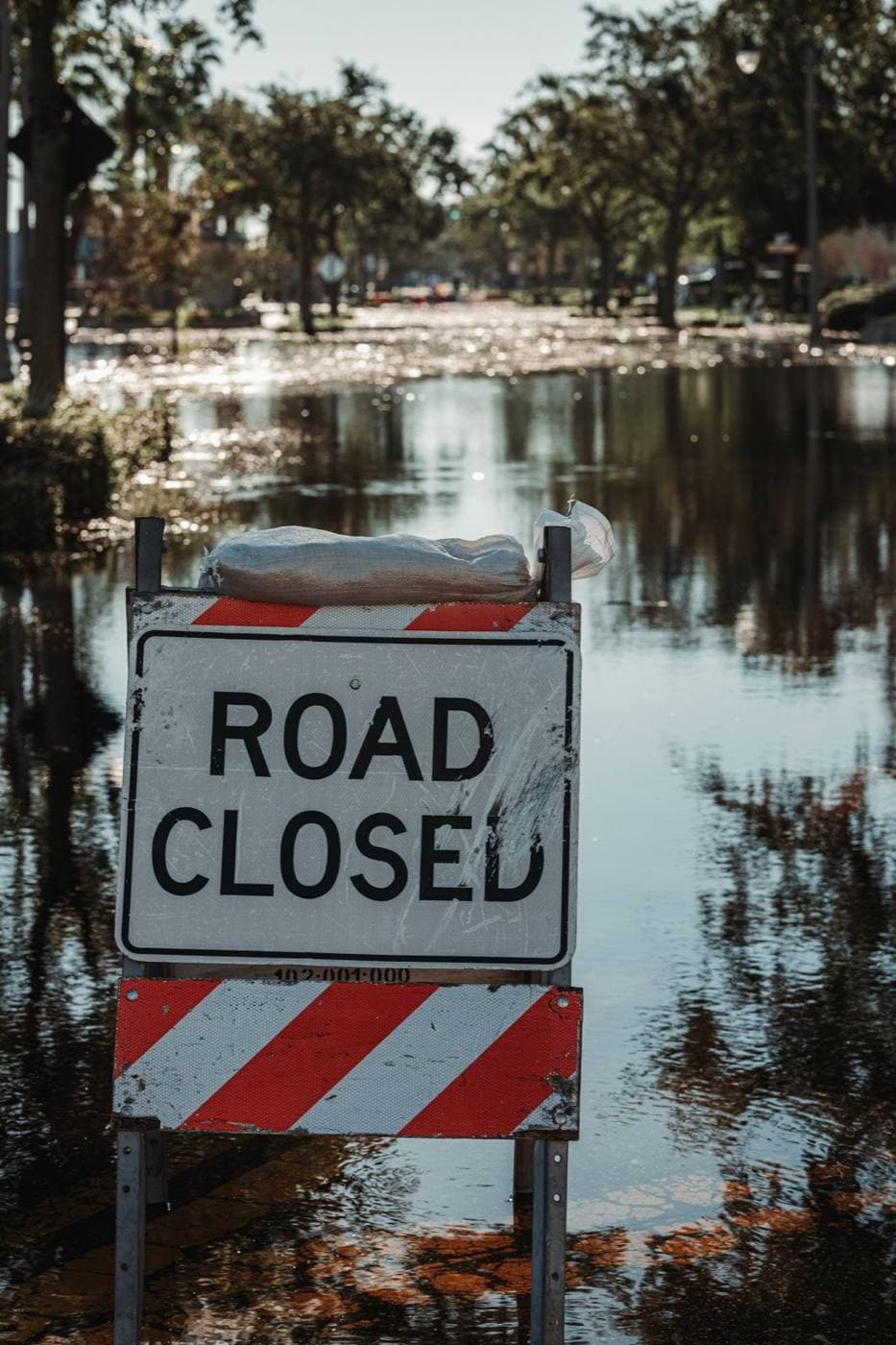 Road closed sign standing in floodwater
